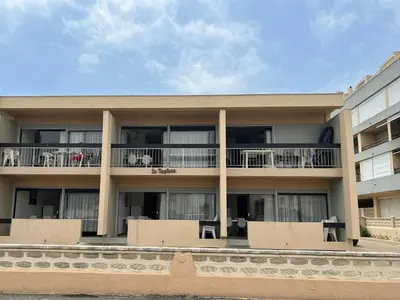 an apartment building with balconies and tables at T2 Climatisé, 5 pers, Parking Protégé, Front de mer - FR-1-797-38 in Port-la-Nouvelle