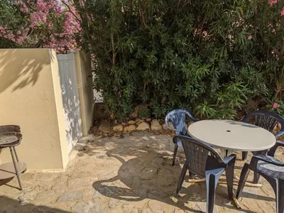 a table and chairs sitting on a patio at Port-la-Nouvelle : T2 proche plage, terrasse, parking, clim, BBQ, lave-linge, 4 pers, classé 2* - FR-1-797-17 in Port-la-Nouvelle