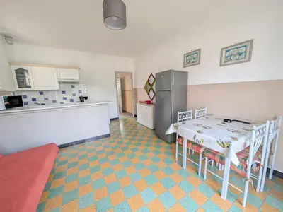 a living room with a couch and a table at Port-la-Nouvelle : T2 proche plage, terrasse, parking, clim, BBQ, lave-linge, 4 pers, classé 2* - FR-1-797-17 in Port-la-Nouvelle