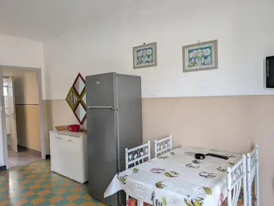 a table and two chairs and a table and a table and chairs at Port-la-Nouvelle : T2 proche plage, terrasse, parking, clim, BBQ, lave-linge, 4 pers, classé 2* - FR-1-797-17 in Port-la-Nouvelle