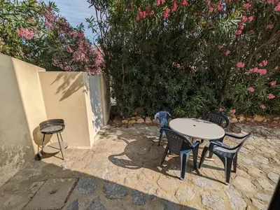 a bedroom with a bed and two windows at Port-la-Nouvelle : T2 proche plage, terrasse, parking, clim, BBQ, lave-linge, 4 pers, classé 2* - FR-1-797-17 in Port-la-Nouvelle
