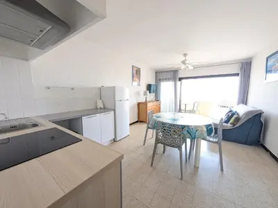 a kitchen and dining room with a table and chairs at T2 en bord de mer pour 4 pers, RDC avec Parking - FR-1-797-39 in Port-la-Nouvelle