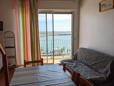 a bedroom with a bed and a view of the ocean at T2 Mezzanine à 250m de la plage pour 4/5 pers avec Parking et TV - FR-1-797-31 in Port-la-Nouvelle