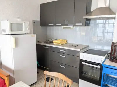a kitchen with a white refrigerator and a microwave at Port-la-Nouvelle : Studio front de mer, 4 pers, parking inclus - FR-1-797-32 in Port-la-Nouvelle