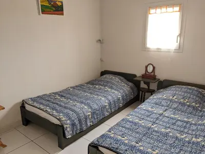 a room with two beds and a window at Belle Villa T3 Mezzanine, à 450m Plage, 5 Pers, Terrasse, Jardin, Garage & Parking - FR-1-797-33 in Port-la-Nouvelle
