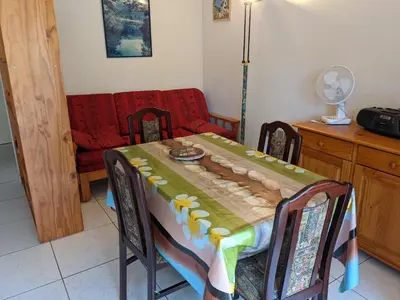 a dining room with a table and a couch at Belle Villa T3 Mezzanine, à 450m Plage, 5 Pers, Terrasse, Jardin, Garage & Parking - FR-1-797-33 in Port-la-Nouvelle