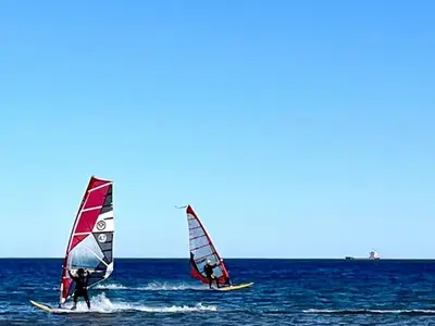 two people windsurfing in the ocean on the water at Charmant T2 proche plage à Port-la-Nouvelle, terrasse et parking inclus - FR-1-797-29 in Port-la-Nouvelle