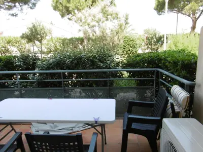 a white table and chairs on a balcony at T3 Climatisé RDC avec Terrasse, Parking, Proche Activités - Port-la-Nouvelle - FR-1-797-30 in Port-la-Nouvelle