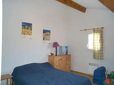 a bedroom with a blue bed and a blue chair at Charmante Maison T2 Mezzanine avec Jardin et Parking, à 500m de la Plage - 6 Pers. - FR-1-797-46 in Port-la-Nouvelle
