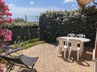 a white table and chairs on a brick patio at Charmante Maison T2 Mezzanine avec Jardin et Parking, à 500m de la Plage - 6 Pers. - FR-1-797-46 in Port-la-Nouvelle