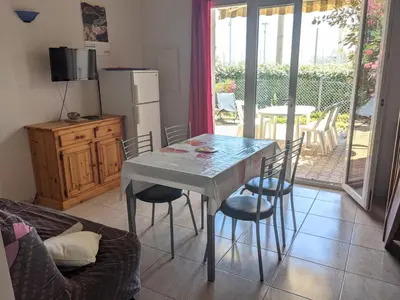 a living room with a table and chairs and a couch at Charmante Maison T2 Mezzanine avec Jardin et Parking, à 500m de la Plage - 6 Pers. - FR-1-797-46 in Port-la-Nouvelle
