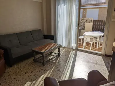 a living room with a couch and a table at Villa T3 climatisée, 57m², 5/6 pers, proche plage, rénovée, terrasse, parking, quartier animé - FR-1-797-48 in Port-la-Nouvelle
