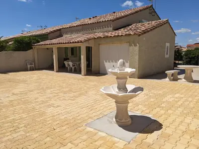 a stone fountain in front of a house at Superbe villa T4 confort avec cour, proche plage - 6 Pers. Parking - FR-1-797-47 in Port-la-Nouvelle