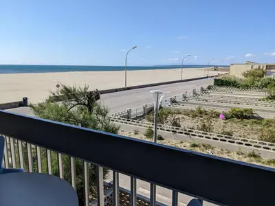 a small boat in the water next to a beach at T2 Moderne Port-la-Nouvelle - 4/5p - Parking - Front de Mer - FR-1-797-41 in Port-la-Nouvelle