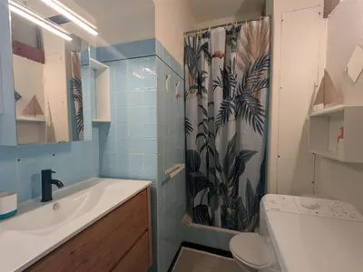 a bathroom with a sink and a shower curtain at T2 Moderne Port-la-Nouvelle - 4/5p - Parking - Front de Mer - FR-1-797-41 in Port-la-Nouvelle