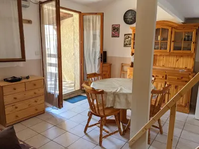 a kitchen and dining room with a table and chairs at Maison T2 avec Mezzanine, Cour et Parking – 5 Pers – Proche Plage et Commerces – Bon Prix - FR-1-797-49 in Port-la-Nouvelle