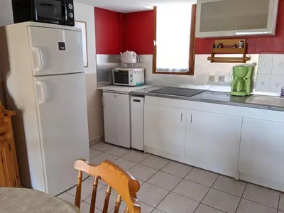 a kitchen with white cabinets and a white refrigerator at Maison T2 avec Mezzanine, Cour et Parking – 5 Pers – Proche Plage et Commerces – Bon Prix - FR-1-797-49 in Port-la-Nouvelle