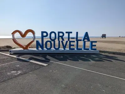 a sign that reads porta nureille in a parking lot at Maison T2 avec Mezzanine, Cour et Parking – 5 Pers – Proche Plage et Commerces – Bon Prix - FR-1-797-49 in Port-la-Nouvelle