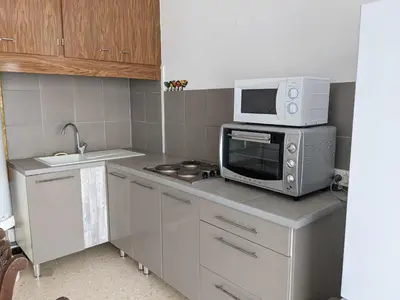a small kitchen with a microwave oven and a microwave at T2 Climatisé, 2 Cours, Proche Plage, Parking Privé, 5 Pers., Animaux Acceptés - FR-1-797-58 in Port-la-Nouvelle