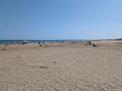 a group of people sitting on a beach at T2 Climatisé, 2 Cours, Proche Plage, Parking Privé, 5 Pers., Animaux Acceptés - FR-1-797-58 in Port-la-Nouvelle