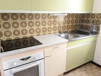 a kitchen with a sink and a counter top at Villa T2 climatisée, 5 pers, proche plage, cour, jardin, barbecue, parking, 2* Meublés Tourisme - FR-1-797-57 in Port-la-Nouvelle