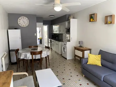 a living room with a blue couch and a table at Villa T2 cosy, 40m², 4 pers, proche plage, 2 terrasses, tout équipé, calme et commerces à proximité - FR-1-797-53 in Port-la-Nouvelle