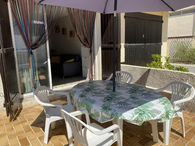 a table and chairs with an umbrella on a patio at Villa T2 cosy, 40m², 4 pers, proche plage, 2 terrasses, tout équipé, calme et commerces à proximité - FR-1-797-53 in Port-la-Nouvelle