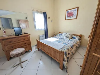 a bedroom with a bed and a desk and a television at Villa T3 Spacieuse à Port-la-Nouvelle – Jardin, Parking, à 900m de la Plage, Chien Admis - FR-1-797-50 in Port-la-Nouvelle
