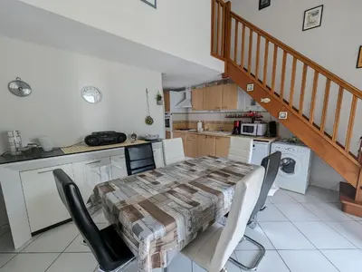 a kitchen and dining room with a table and chairs at Villa T3 Spacieuse à Port-la-Nouvelle – Jardin, Parking, à 900m de la Plage, Chien Admis - FR-1-797-50 in Port-la-Nouvelle
