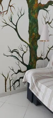 a bedroom with a tree mural on the wall at maison pour vacance a la mer in Port-la-Nouvelle