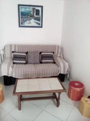 a living room with a couch and a coffee table at maison pour vacance a la mer in Port-la-Nouvelle