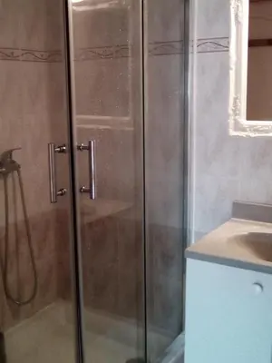 a kitchen with a washing machine and a staircase at maison pour vacance a la mer in Port-la-Nouvelle