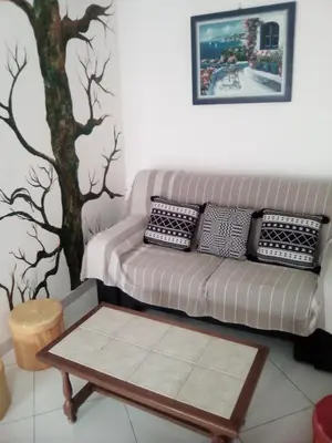 a living room with a couch and a coffee table at maison pour vacance a la mer in Port-la-Nouvelle
