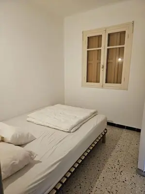 a bedroom with two beds and a window at Gruissan plage des chalets petit logement en rdc in Gruissan