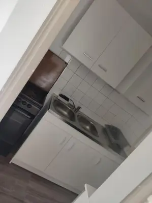 an overhead view of a kitchen with white cabinets at Gruissan plage des chalets petit logement en rdc in Gruissan
