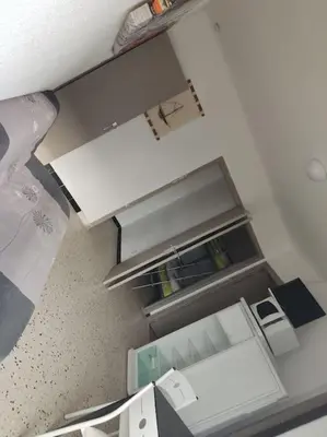 an overhead view of an empty refrigerator with its door open at Gruissan plage des chalets petit logement en rdc in Gruissan