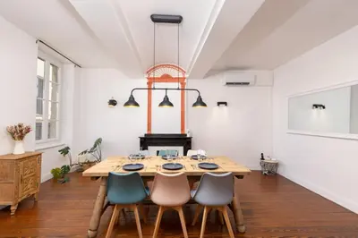 a dining room with a wooden table and chairs at Le Grand Authentique in Carcassonne