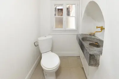 a bathroom with a toilet and a sink at Le Grand Authentique in Carcassonne