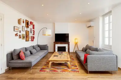a living room with two couches and a coffee table at Le Grand Authentique in Carcassonne