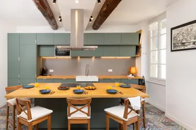 a kitchen with a large wooden table and chairs at Le Grand Authentique in Carcassonne
