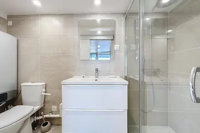 a bathroom with a toilet and a sink and a shower at Studio with pool near the harbor in Gruissan
