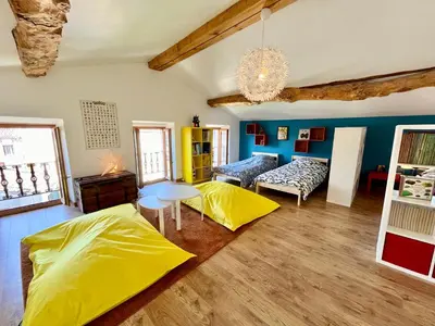 a living room with yellow sheets on the floor at La circulade - Maison de caractère avec jardin in Bram