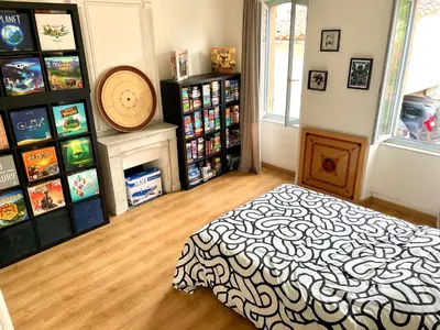 a bedroom with a bed in a room with video games at La circulade - Maison de caractère avec jardin in Bram