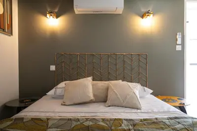 a bed with two pillows on it in a bedroom at L'atelier de 1900 in Puicheric