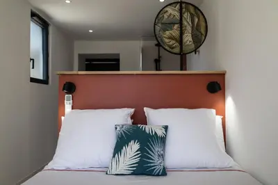 a bedroom with a bed with two pillows at L'atelier de 1900 in Puicheric