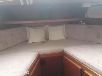 two cushioned seats in a small room in a boat at Appartement bateau Narbonne in Narbonne