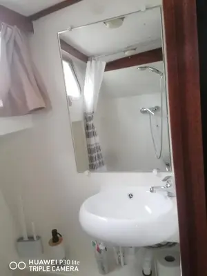 a bathroom with a sink and a mirror at Appartement bateau Narbonne in Narbonne