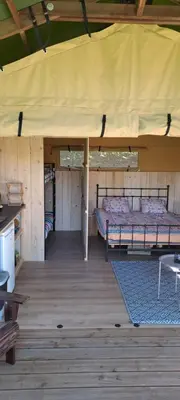 a bedroom with a bed in a tent at Lodge Safari tent in Camurac