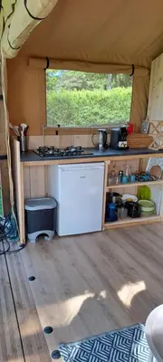 a kitchen in a tent with a white refrigerator at Lodge Safari tent in Camurac
