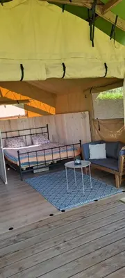 a tent with two beds and a table under it at Lodge Safari tent in Camurac